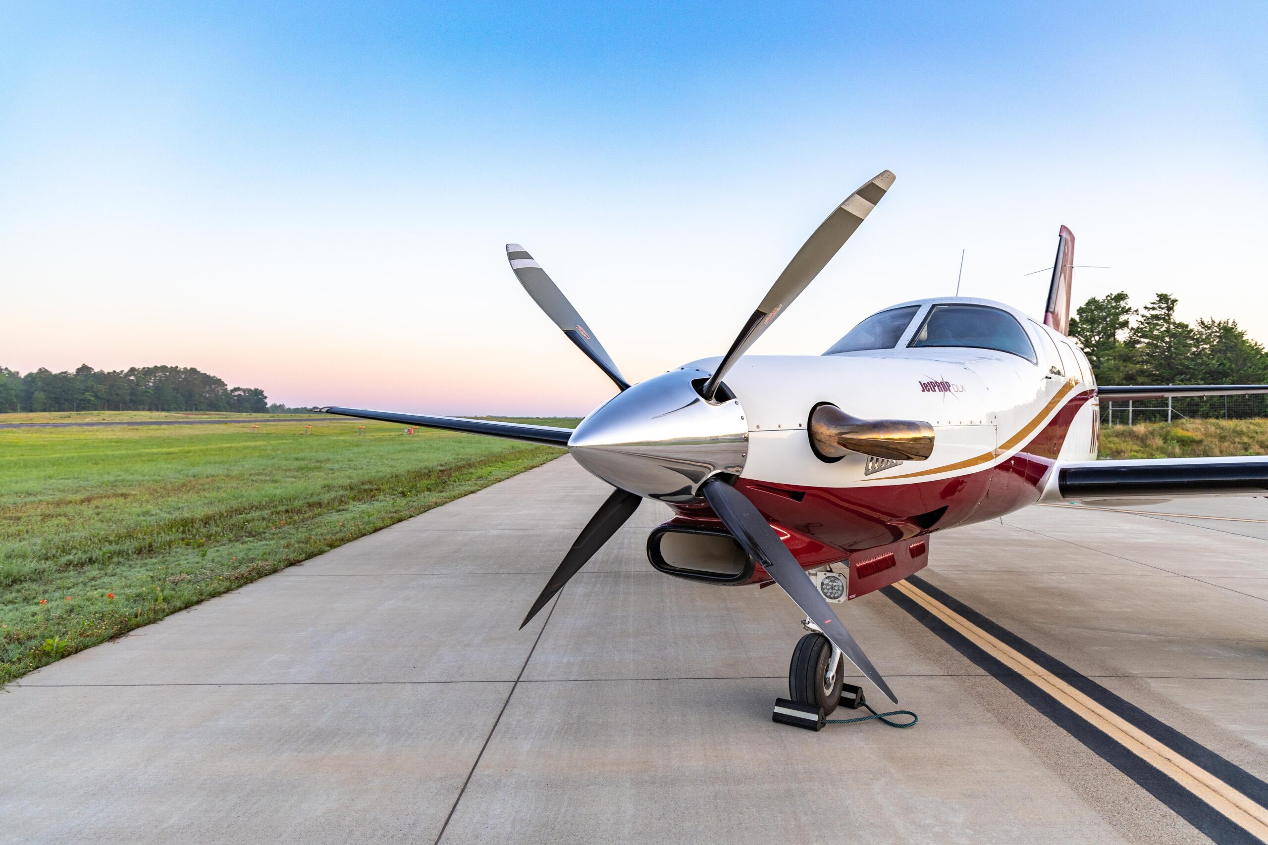 Piper PA-46 JetPROP DLX single-engine turboprop on the ramp at sunrise